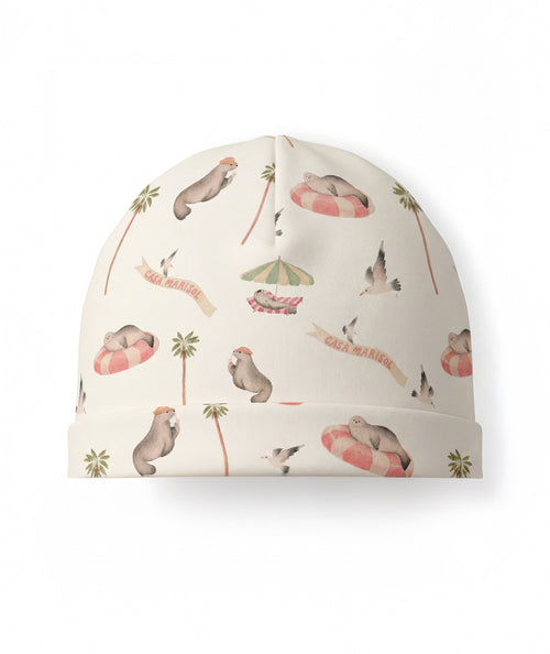 Beanie with seal and palm tree pattern on a white background