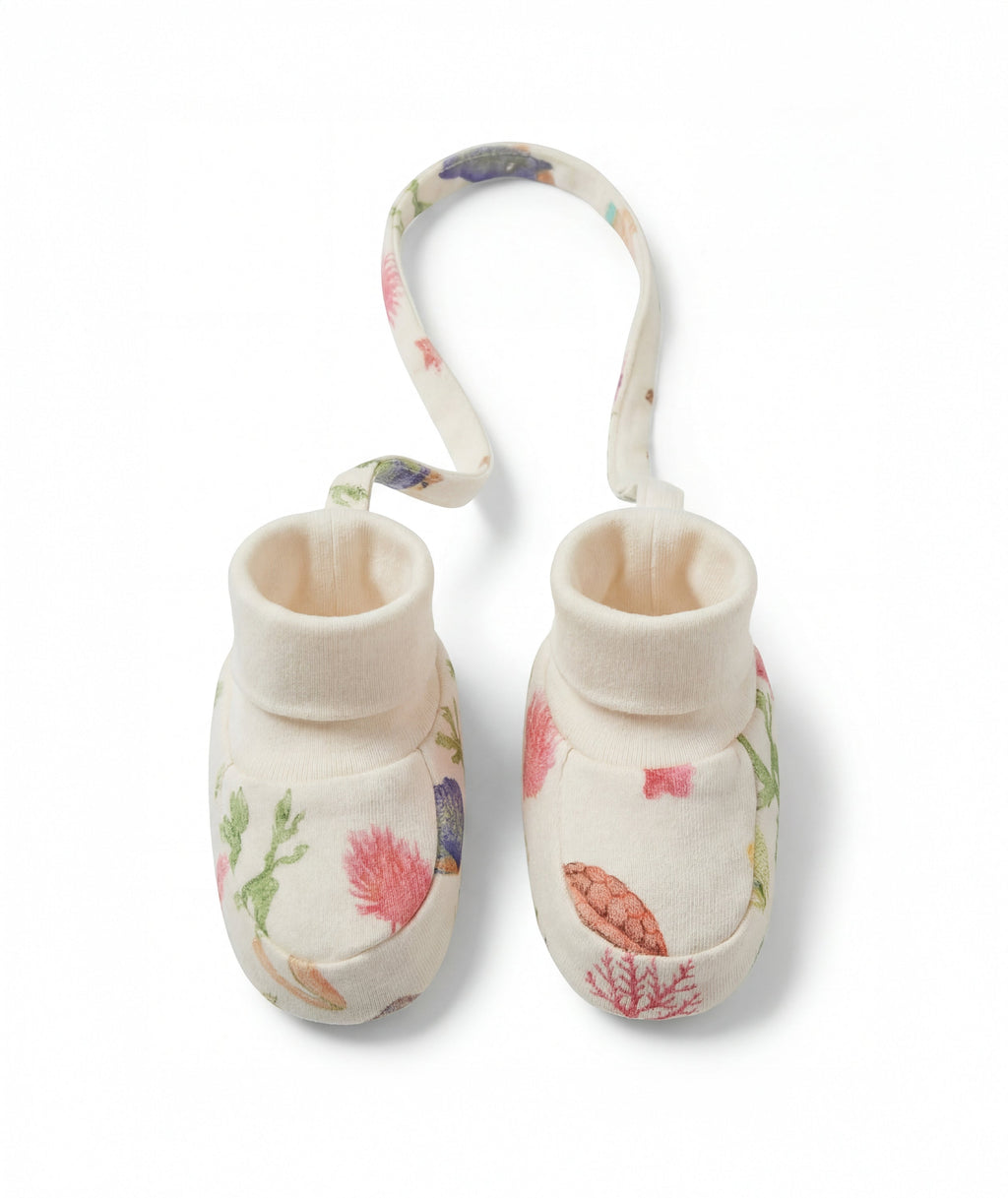 Pair of baby booties with floral design on a white background